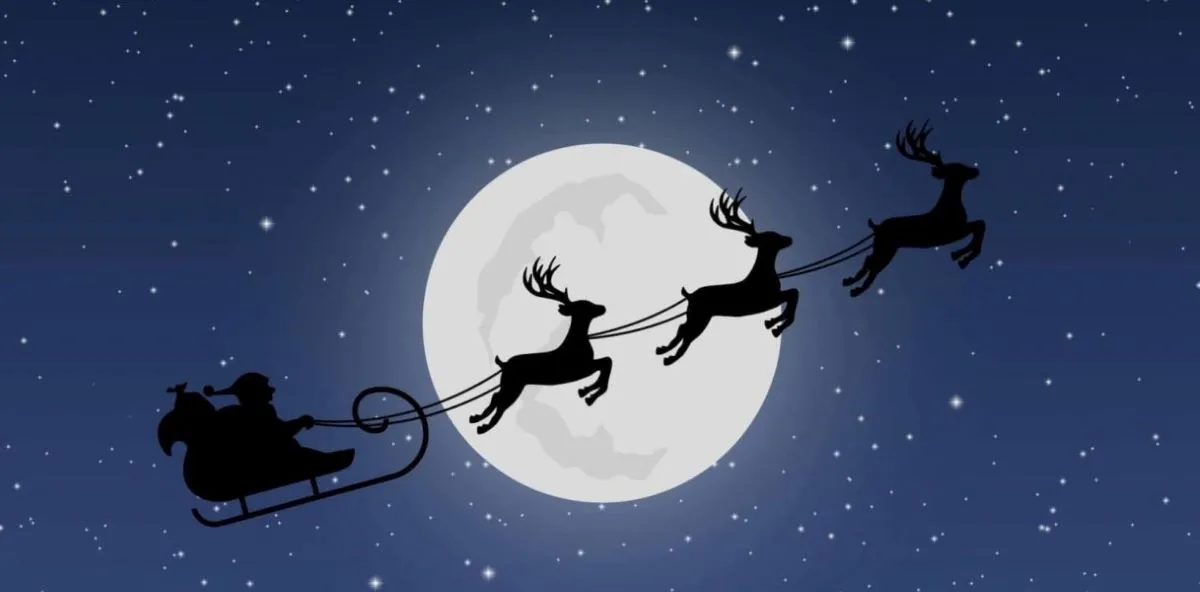 A starry sky with a moon in the center. Santa is passing through with his reindeer and sleigh.