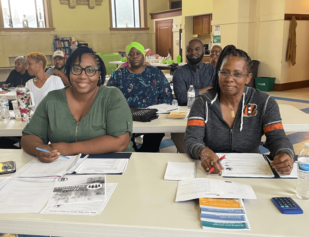 Several rows of women and men attending a Homebuyer Class at Working In Neighborhoods. Virtual Homebuyer Training Classes are held over Zoom,