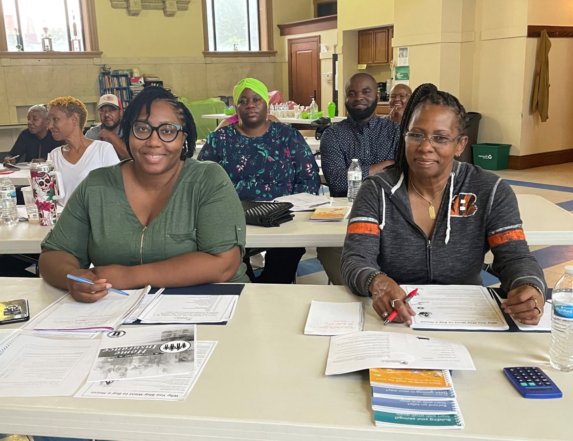 Several rows of women and men attending a Homebuyer Class at Working In Neighborhoods. Virtual Homebuyer Training Classes are held over Zoom,