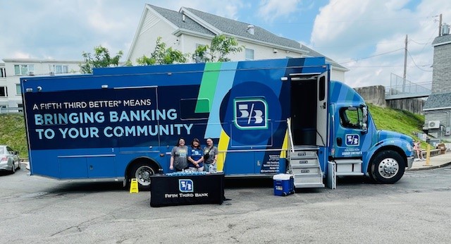 The Fifth Third Bank eBus with three Fifth Third employees standing in front of it.
