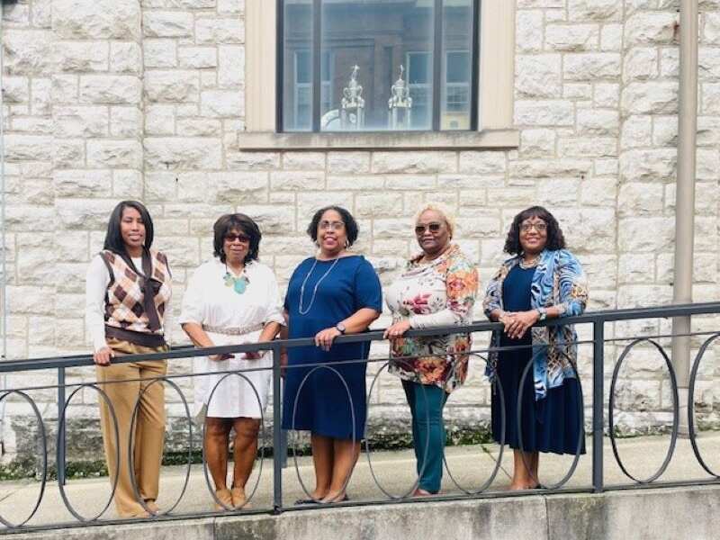 The five members of WIN's housing team pose outside celebrating Housing Counselor Day.