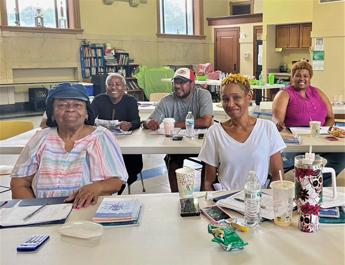 Several rows of women and men attending a Homebuyer Class at Working In Neighborhoods. Virtual Homebuyer Training Classes are held over Zoom,