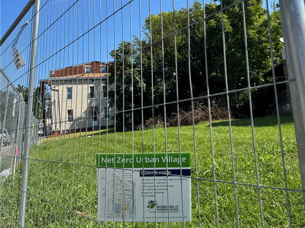 A fenced in lot is the site of the next two new homes in WIN's Near-Net-Zero Urban Village.